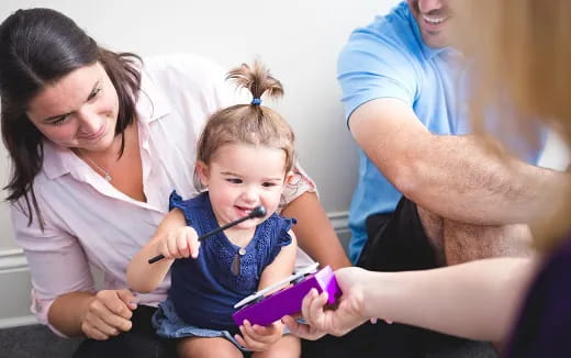 a group of people looking at a child