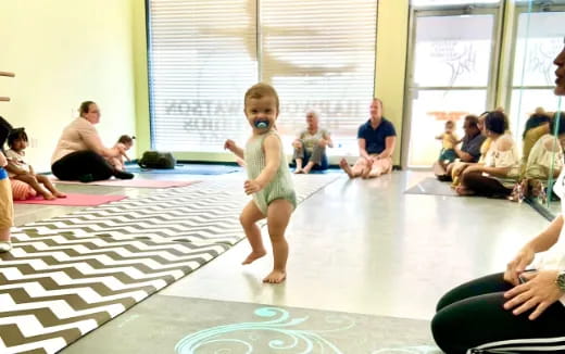 a child standing on a mat