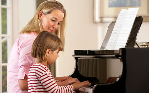 a person and a child looking at a computer
