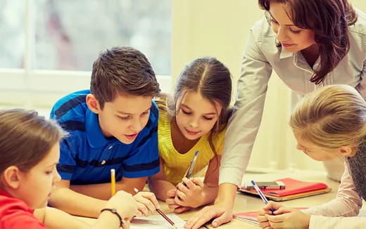 a person and several children studying