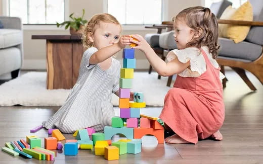 a couple of children playing with toys