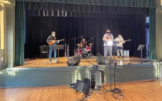 a group of people playing instruments on a stage