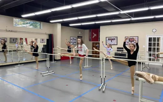 a group of women exercising in a gym