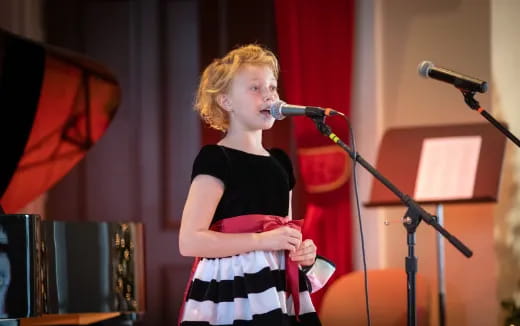 a person singing into a microphone