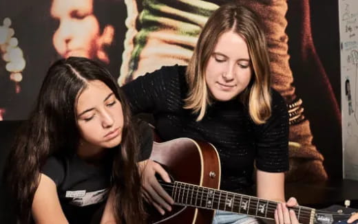 a group of women playing guitar