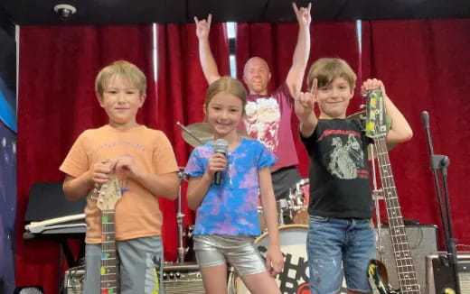 a group of kids holding microphones