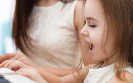 a young girl looking at a book
