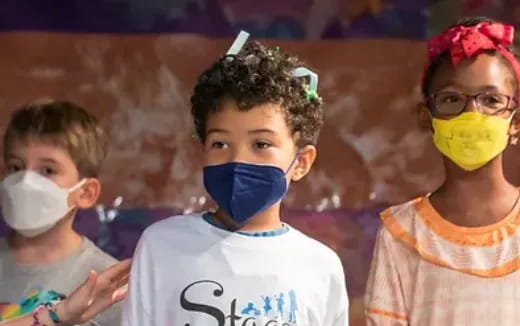 a group of children wearing face masks