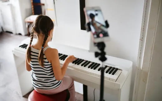 a woman playing a piano