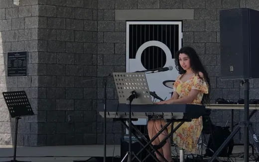 a woman playing a keyboard