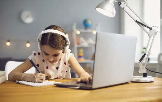 a young girl using a laptop