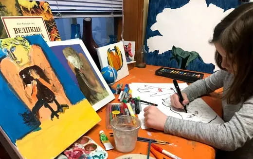 a girl painting on a table