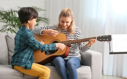 a man and a woman playing a guitar