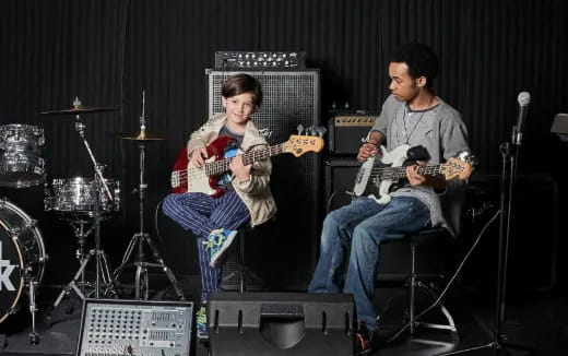 a couple of men playing guitars on a stage
