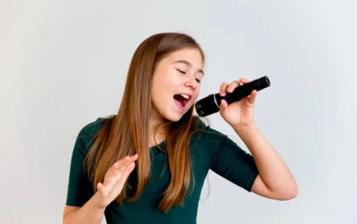 a woman singing into a microphone