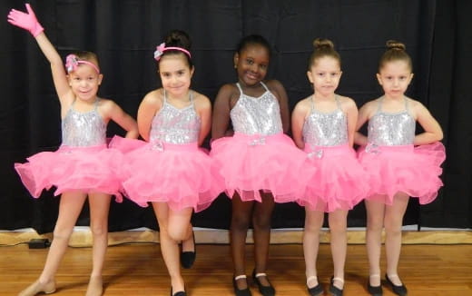 a group of girls in dresses