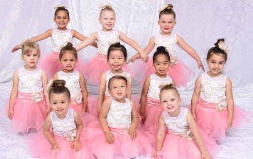 a group of girls in dresses