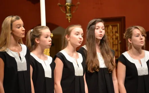 a group of women in black dresses