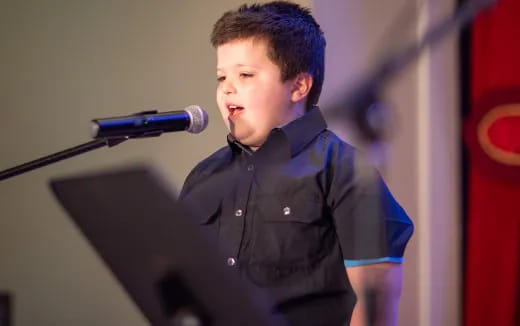 a boy standing at a podium