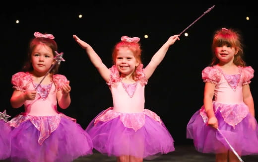 a group of girls in dresses