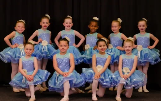 a group of girls in blue dresses