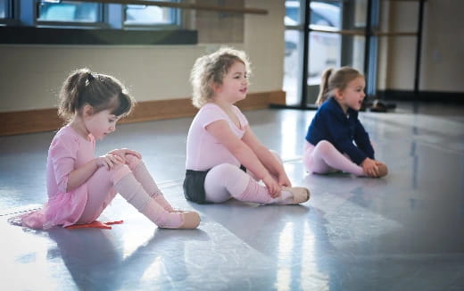 a group of girls sitting on the floor
