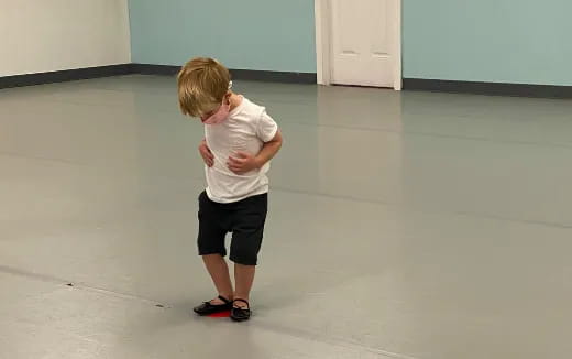 a boy standing in a room