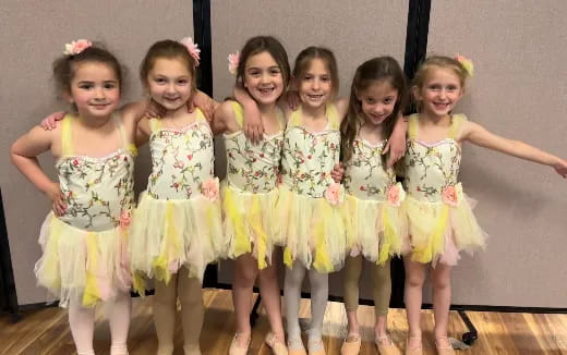 a group of girls in dresses