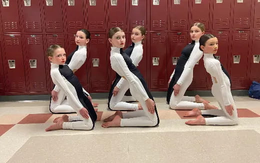 a group of women in white karate uniforms