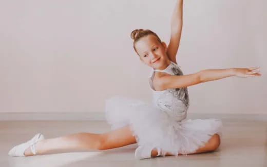 a person in white ballet outfit