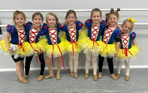 a group of girls in matching outfits