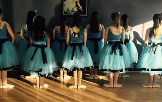 a group of women in dresses dancing