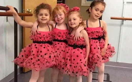 a group of girls in dresses