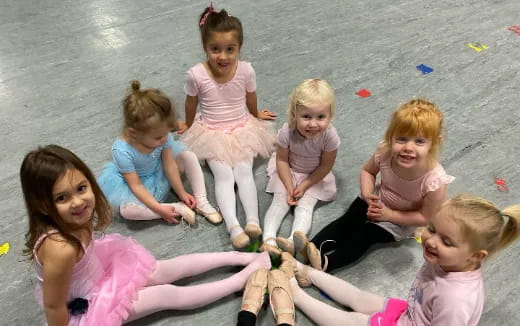 a group of children sitting on a beach