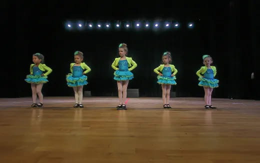 a group of girls in clothing on a stage