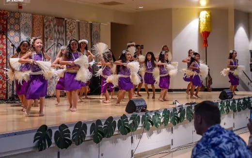 a group of women performing on a stage