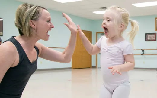 a woman and a girl dancing