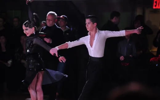 a person dancing with a crowd watching