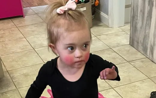 a child with a bow on their head
