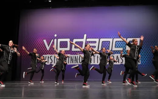 a group of people dancing on a stage