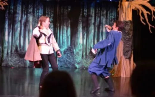 a man and woman dancing on a stage