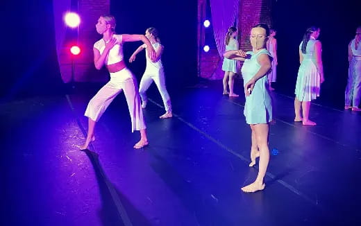 a group of people dancing on a stage