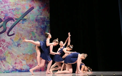 a group of people dancing on a stage