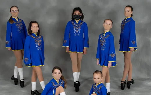a group of people in blue dresses