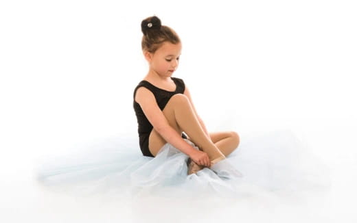 a person sitting on a white sheet