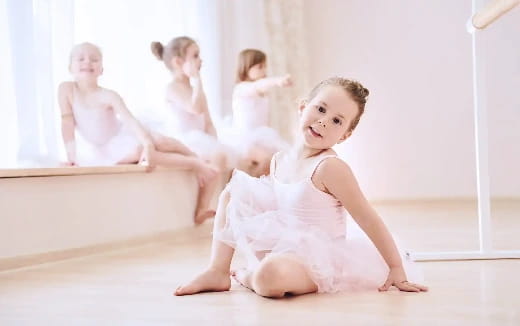 a group of children in white dresses