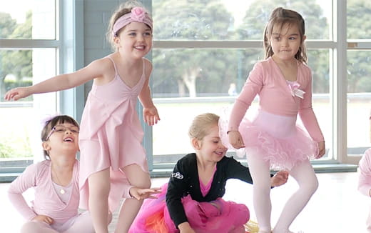 a group of girls in dresses