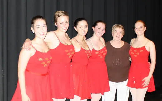 a group of women posing for a photo