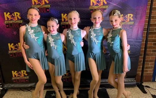 a group of girls in dresses