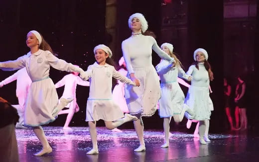 a group of girls dancing on a stage